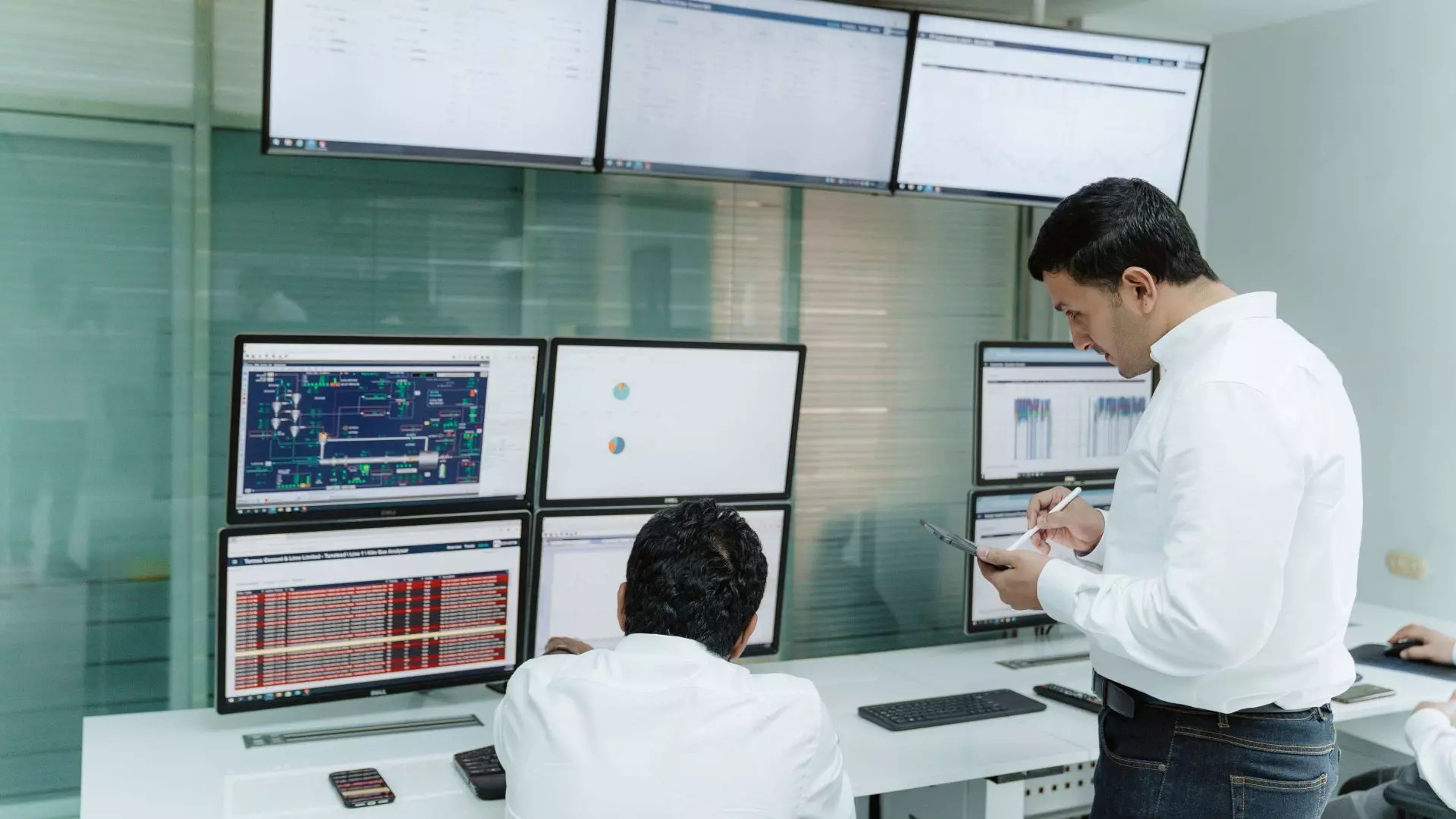 two people working remote with monitors