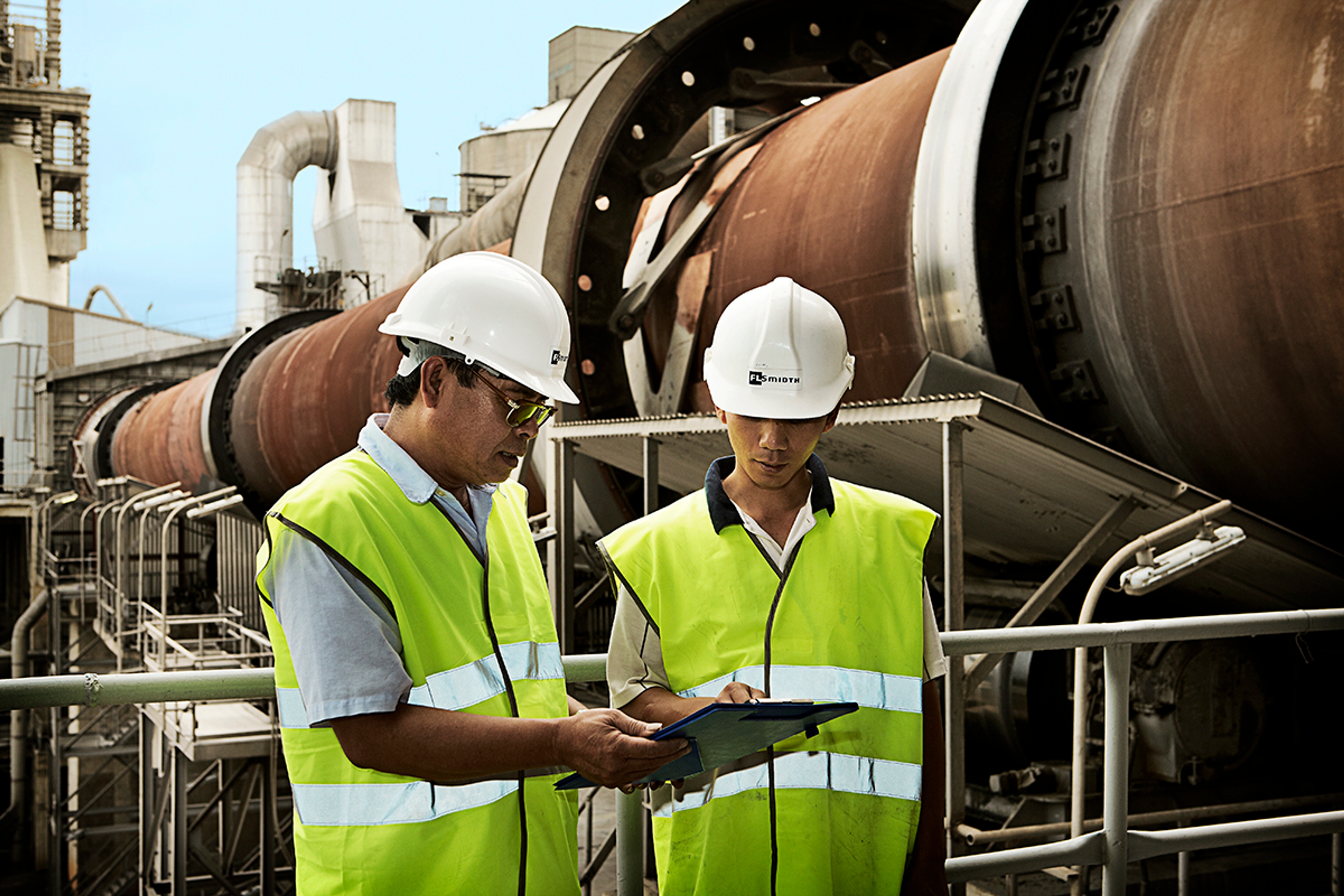 two people working in front of a kiln