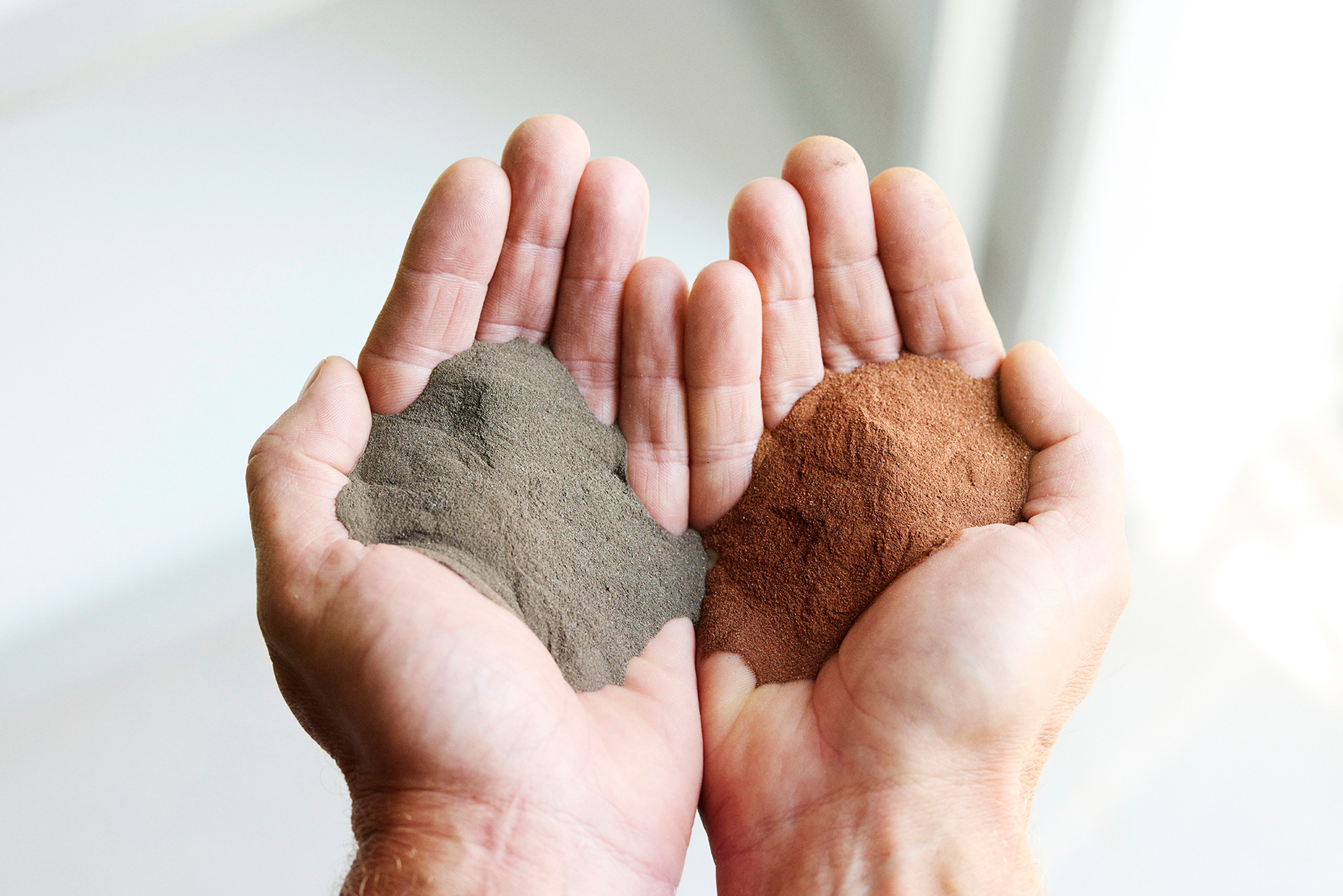 two hands with calcined clay comparison